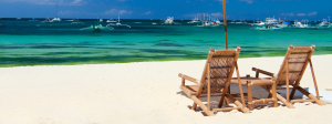 Chairs on a beach with the water in the background